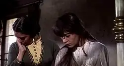Black and white film still from One-Eyed Jacks showing Katy Jurado with Pina Pellicer in a different scene