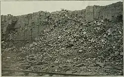 Photo of the original open-cast mine on Bell Island (c. 1900). The railway in the foreground was intended for mine carts.[39]