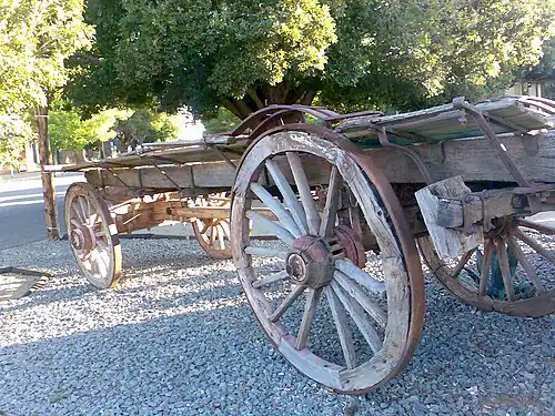 Ox-wagon with four wagon wheels.