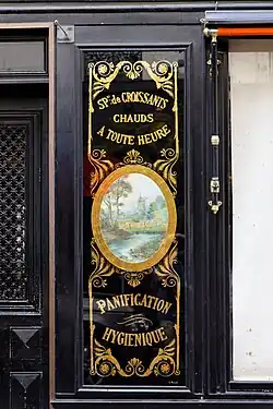 Neoclassical medallion on the facade of Le Moulin de la Vierge (Rue Saint-Dominique no. 64), Paris, by Benits et Fils, c. 1900[14]