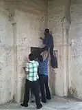 People defacing the walls of the Golconda Fort in Hyderabad, India