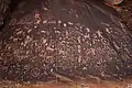 Petroglyphs at Newspaper Rock State Historic Monument carved into desert varnish