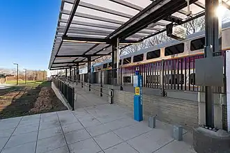 A passenger train at a high-level platform