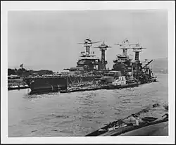 West Virginia (right) sunk alongside Tennessee after the attack