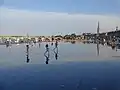 The Miroir d'eau, the Pont de pierre and the Basilica of St. Michael.