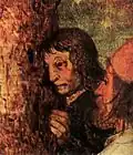 Two figures at the base of the pole