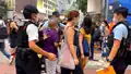 A PTU police officer pushing an elderly into defense line to stop and search[42]
