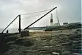 Red Crane with Portland Bill Lighthouse in the background.