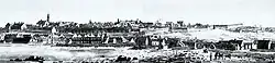 An illustration of Quebec City, with many buildings surrounding the waterfront to the bottom left. City walls may be observed in the background.