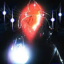 A heavily edited photograph of a man holding a lantern with a bird on his knee. A bright red glow is seen in the top-center, while a bright white glow is seen in the bottom-left. Printed on top, it reads: "Red Light" in heavily stylized and faint text