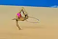 Suspending the hoop from the neck while rotating (Takana Tatsuzawa)