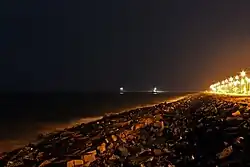 Promenade beach at night showing harbor