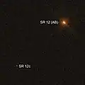 Hubble image of SR 12 binary (upper right) and SR 12c (lower left). The orange part of the image shows H-alpha.