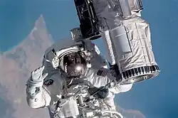 STS104-315-013 (July 12–24, 2001) --- Holding onto the end effector of the Canadarm on the Space Shuttle Atlantis, astronaut Michael L. Gernhardt, STS-104 mission specialist, participates in one of three STS-104 space walks.