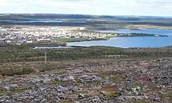 A village on a lake surrounded by barren land