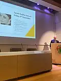 Hughes presenting the Sarah Hughes Trust Lectureship, RSM, London (2021)