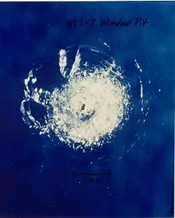 Window pit caused by impact of space debris