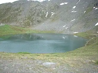 Looking down on Summit Lake during the late summer with a few patches of snow still visible on the rock glacier in the background