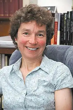 colour portrait photograph of Susan Manning in her office in IASH, University of Edinburgh