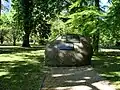 A rock with a plaque dedicated to child camp followers.