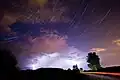 The constellation of Cassiopeia over a thunderstorm.
