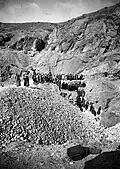 Excavations in the northern area of the necropolis, 1906. Above in the background, the entrance of the tomb TT10.