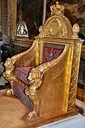 Throne; by Bernard Poyet and François-Honoré-Georges Jacob-Desmalter; 1805; carved and gilded wood, covered in red velvet with silver embroidery; 160 x 110 x 82&nbsp;cm; Musée des Arts Décoratifs (Paris)[13]