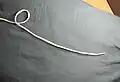 2. Start an overhand knot, leaving enough rope for the loop and the rest of the knot.
