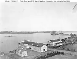 USNA waterfront in the late 1860s with the barrack/school ships USS Constitution and Santee tied up in the background. Other ships not identified.