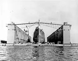 Cruiser Columbia (CL-56) docked in Artisan (ABSD-1) at Espiritu Santo in January 1944