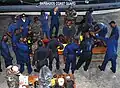 Members of the BDF disassemble a boat engine during training exercises with the US Navy