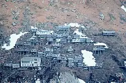 Abandoned stilt village, photographed 1978. The large white building near the bottom of the slope is the former Bureau of Indian Affairs school.