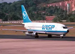 A large blue-and-white plane on the tarmac, seen from the front