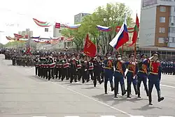 The Transnistrian state flag displayed alongside the Russian flag at the 2017 Victory Day parade in Tiraspol