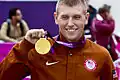 Vincent Hancock with his gold medal at the 2012 Summer Olympics, the heaviest Summer Olympics medal prior to the 2016 Rio Olympics[46]