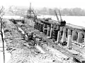 Construction of Wilson Dam under way around 1919. Jackson Island, seen in the background, is now covered by Lake Wilson.