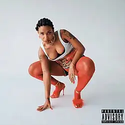 Bey crouching and looking to the camera