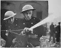 London firemen wearing Brodie-like steel helmets during World War II